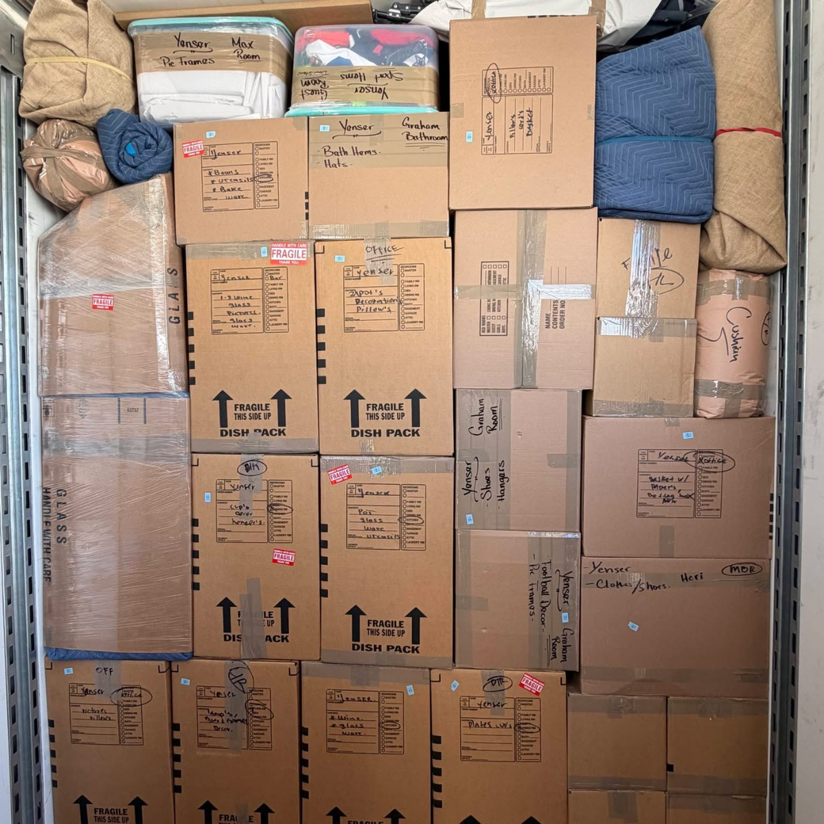 Stacked labeled fragile boxes loaded in truck