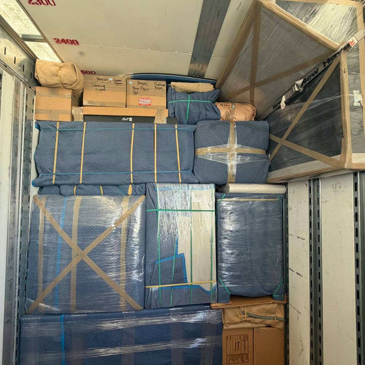 Wrapped furniture secured in moving truck