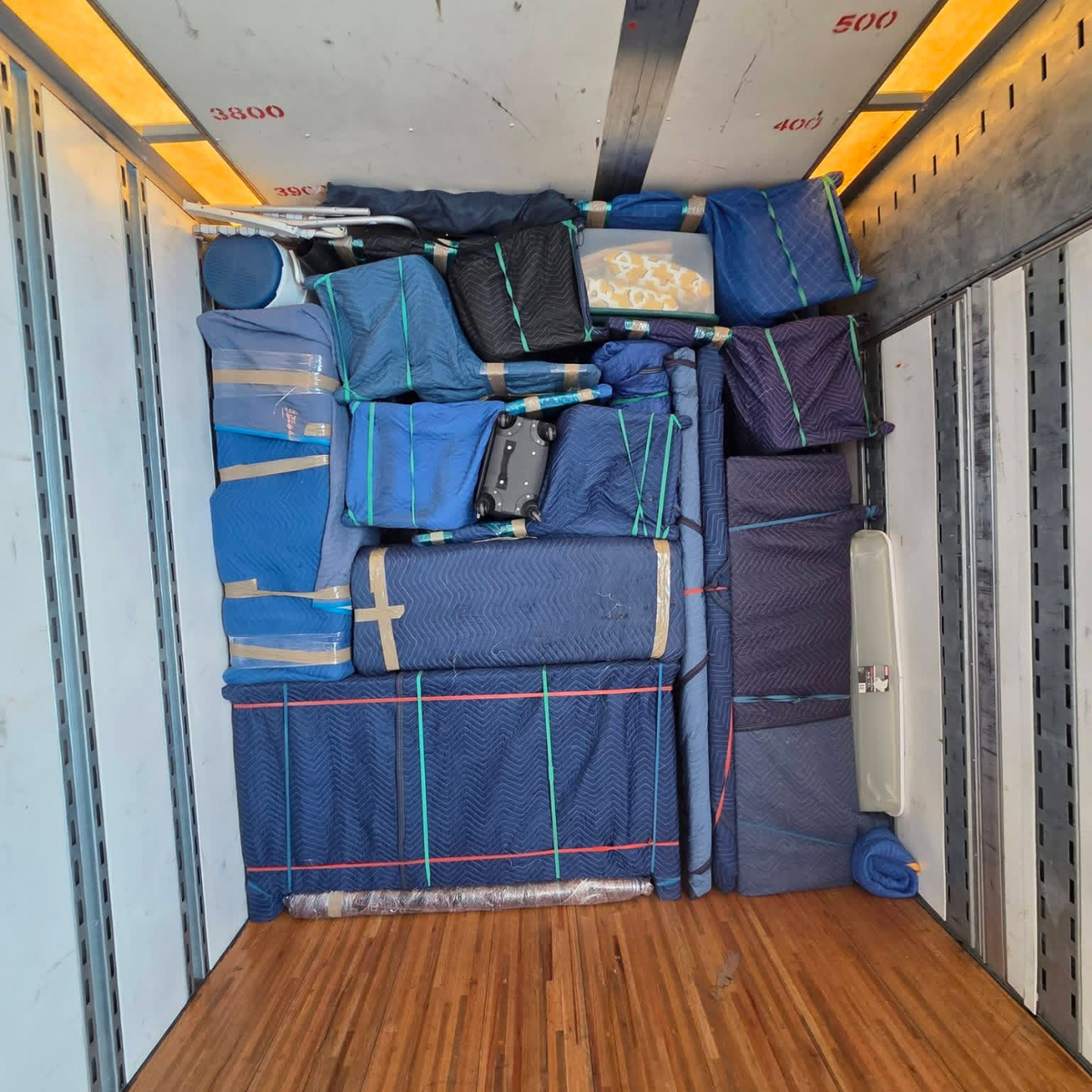 Blanket-wrapped furniture load in truck